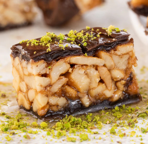 Close-up of chocolate-dipped baklava with nut filling